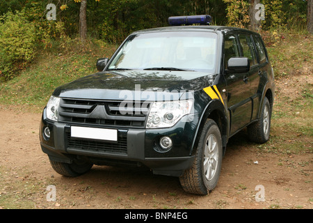 Special force`s patrol jeep in forest. Stock Photo